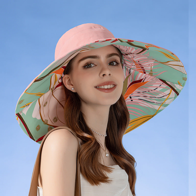 Woman wearing a colorful floral sun hat on a white background