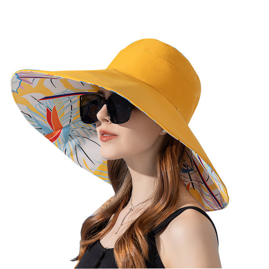 Woman wearing a yellow sun hat with a colorful floral interior on a white background