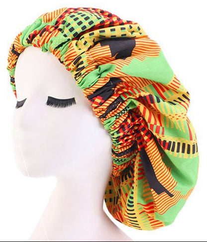 Colorful patterned bonnet with satin lining and elastic band on a mannequin head.