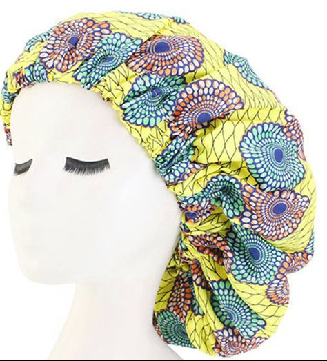 Colorful patterned headscarf on a mannequin head with a plain white background