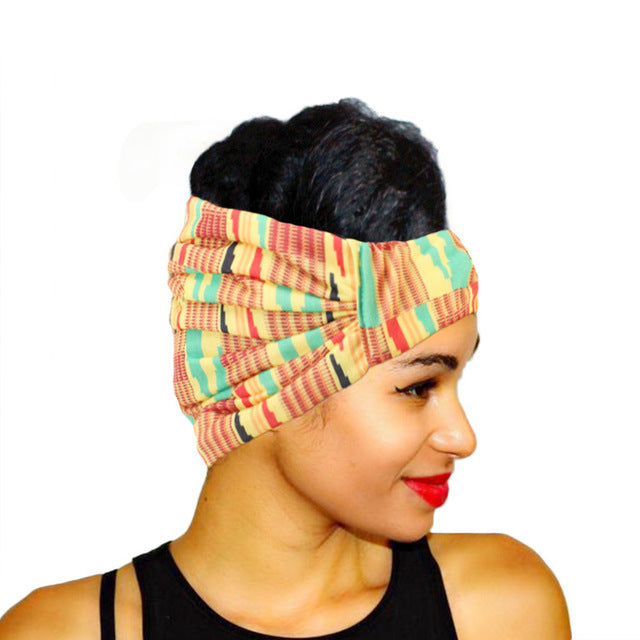 Woman wearing a colorful patterned head wrap on a white background