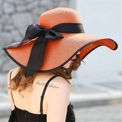 Foldable women's sun hat packed flat, showing travel-friendly flexible brim design