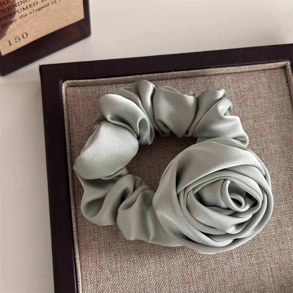 Light gray scrunchie on a textured surface