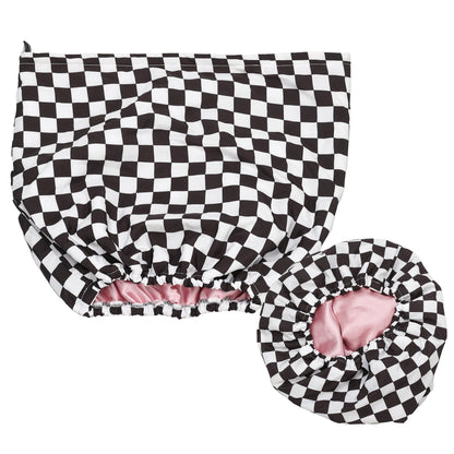 Black and white checkered shower cap with pink interior on a white background