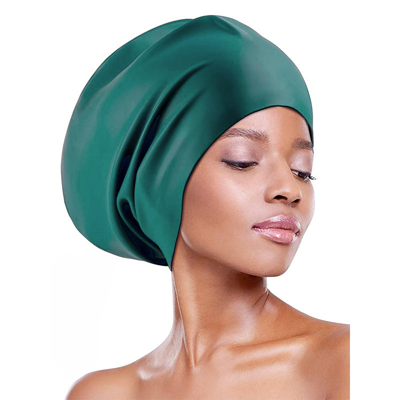 Extra-large waterproof silicone swimming cap designed to fully cover hair and protect ears, featuring a non-squeezing head fit for comfort during swimming