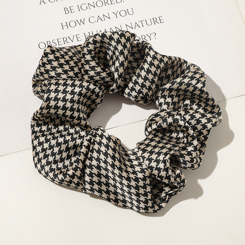 Houndstooth patterned scrunchie on a light background